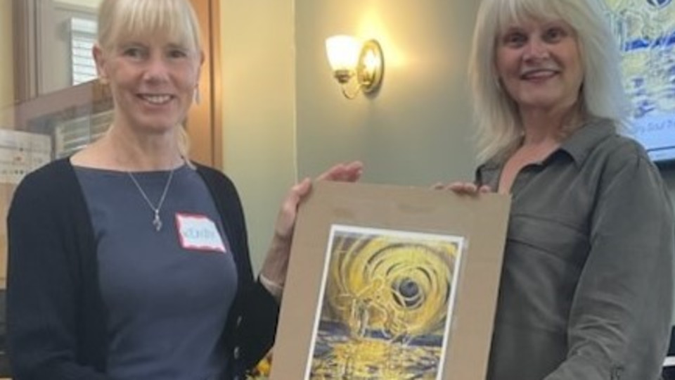 West End Living Library volunteer, Wendy Weller-Davies, receiving the donated first print of "Soul Treats" for WESN from Artist, Kathleen Tonnesen. Photo credit: Wendy Weller-Davies