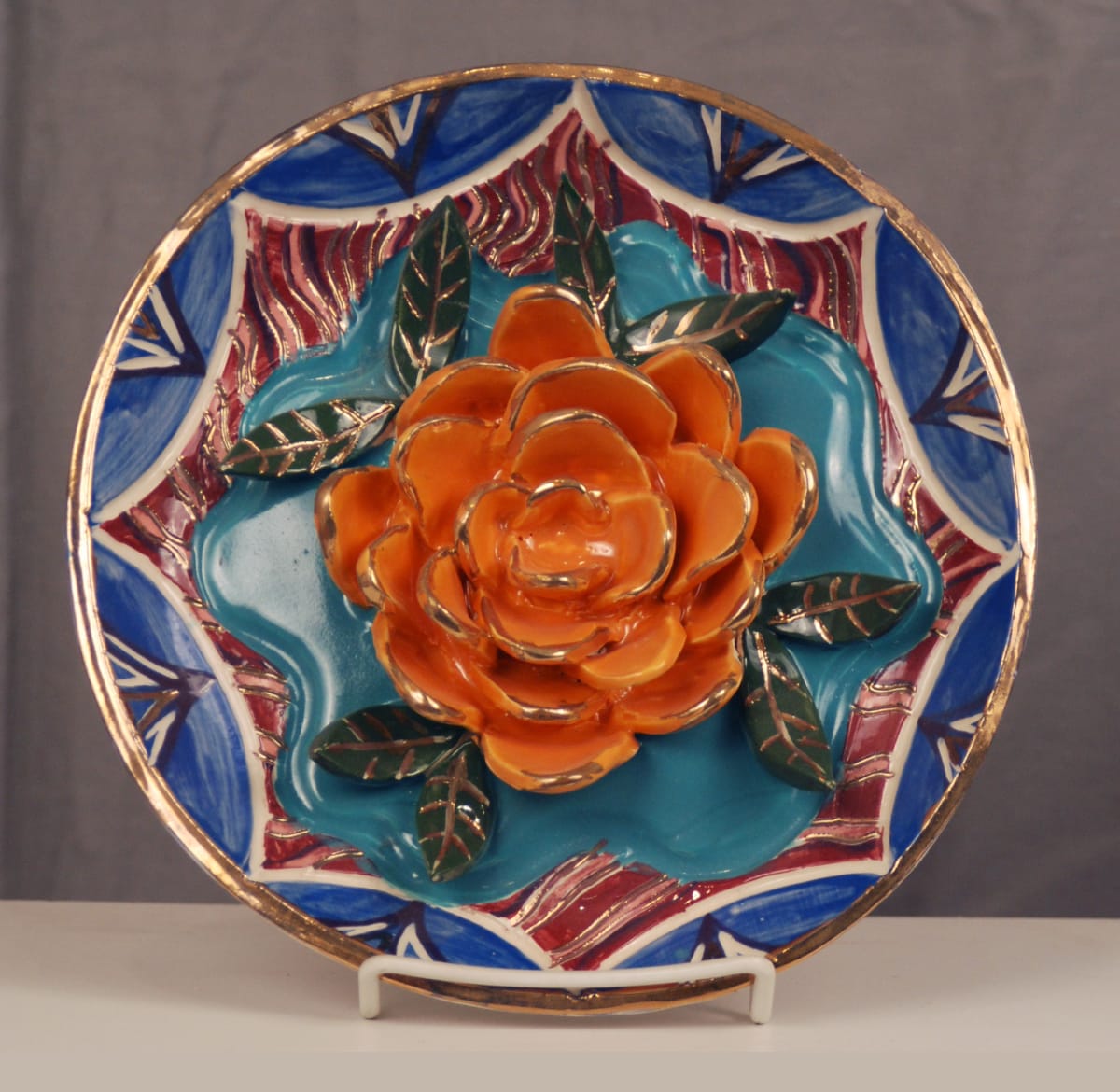 (orange flower on turquoise center) by Janet Hoelzel 