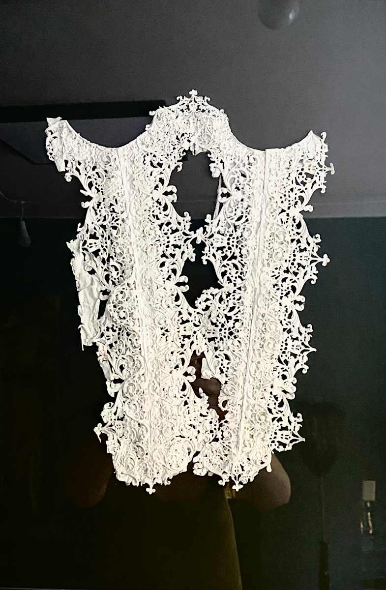 Corset I by Ingrid Lauw Peña  Image: Prenda realizada excusivamente con pintura acrílica, enmarcada. Fondo gris, marco de caja negro.