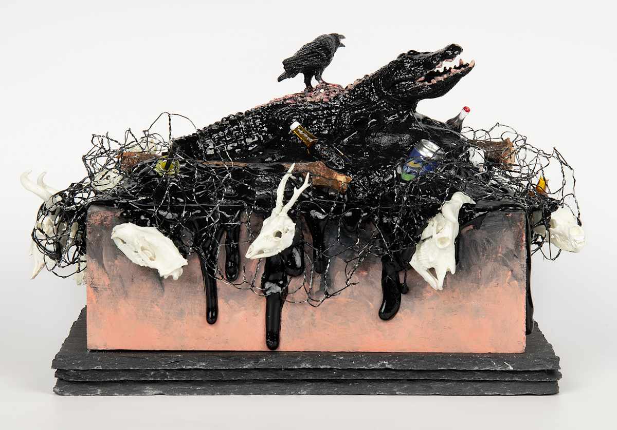 Tar Pits VII: Crocodile. by Lynette K Henderson  Image: Tar Pits VII: Crocodile.  Wood, paper clay, slate, glue, wire, found objects, acrylic; 9" x 6" x 7.5", 2024