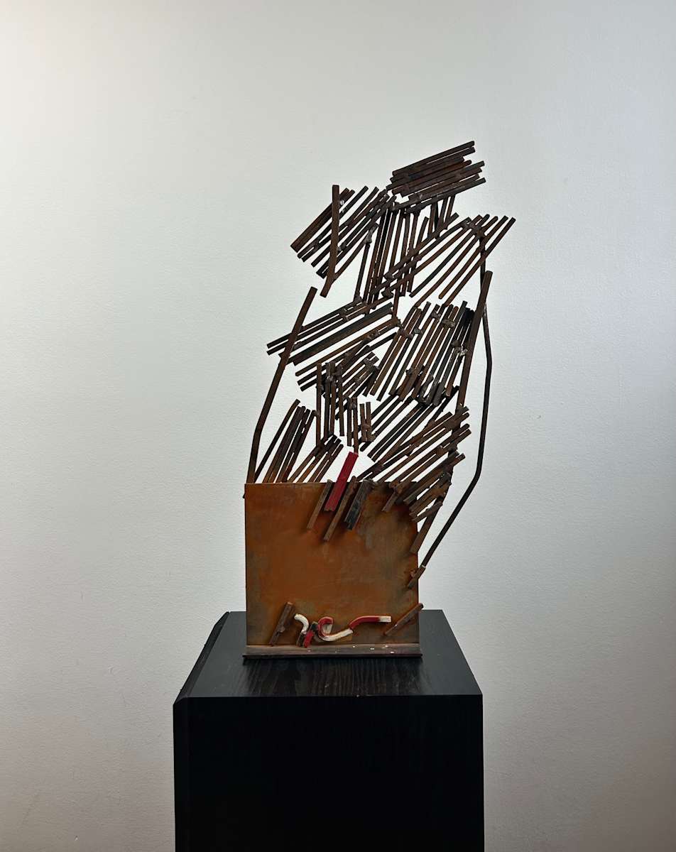 Untitled by Ruggero Gamberini  Image: This untitled 1990 sculpture by Ruggero Gamberini explores the expressive potential of industrial materials. A structured explosion of iron rods ascends from a rusted sheet metal base, balancing tension with fragility. The piece captures a sense of upward energy - like a system on the verge of coherence or collapse - while remaining elegantly unresolved.