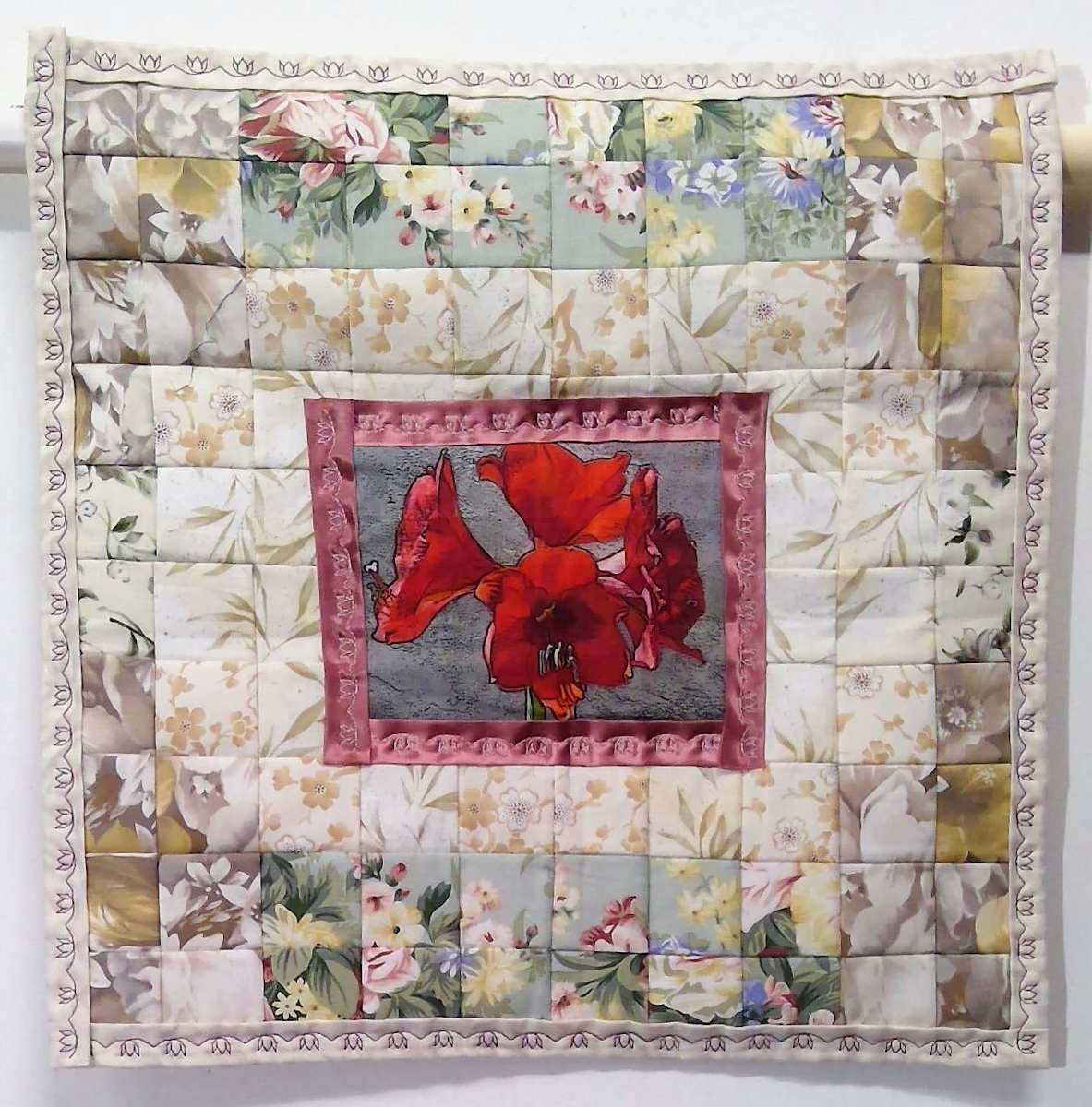 Amaryllis by Katrina Sjoberg  Image: I have many smaller patchwork wall quilts that I have modernised by adding decorative machine stitching and a central image of a flower.