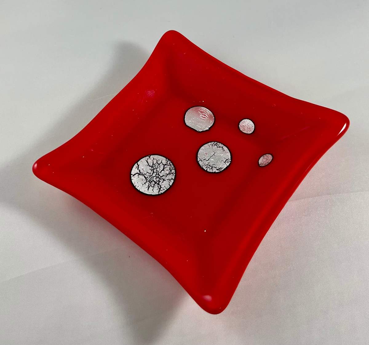 small red dish with silver foil by Julie Root Sawyer, Image 1.
