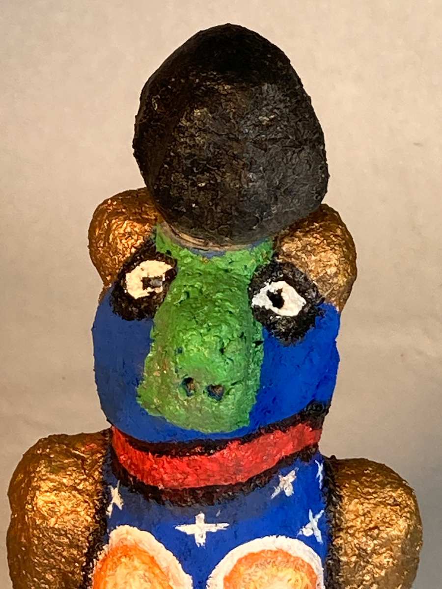 Blue face with green nose and black hat by Jennifer Taylor 