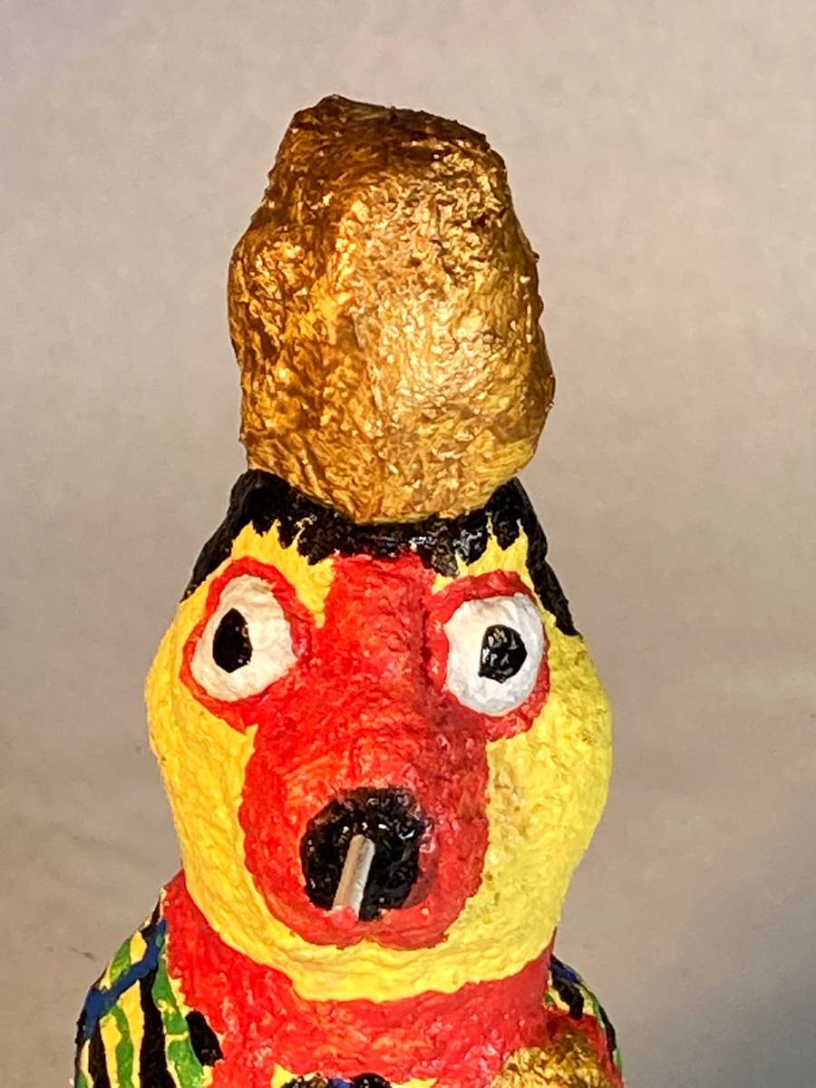 Yellow face smoking with black hair and gold hat by Jennifer Taylor 