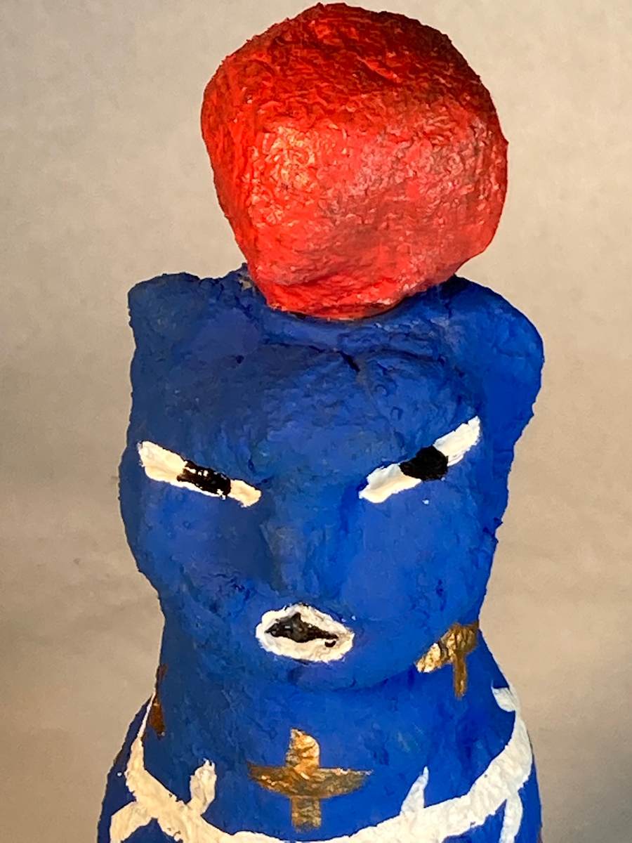 Blue face and barbed wire with red hat by Jennifer Taylor 