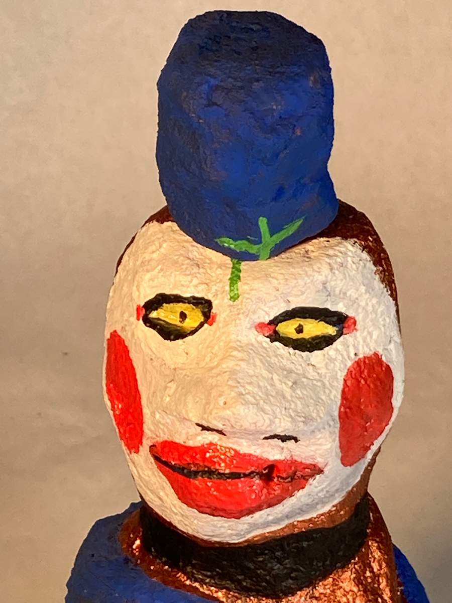 White face with red cheeks and blue hat by Jennifer Taylor 