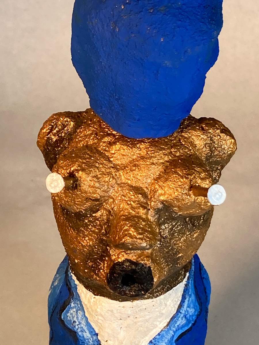 Gold face with nails and blue hat by Jennifer Taylor 