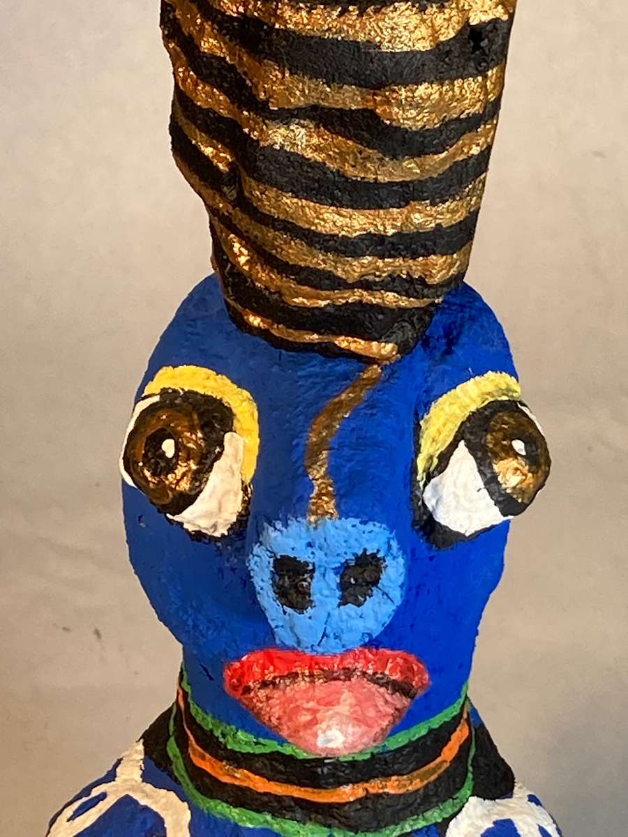 Blue Face with black and gold hat and nails in back by Jennifer Taylor 