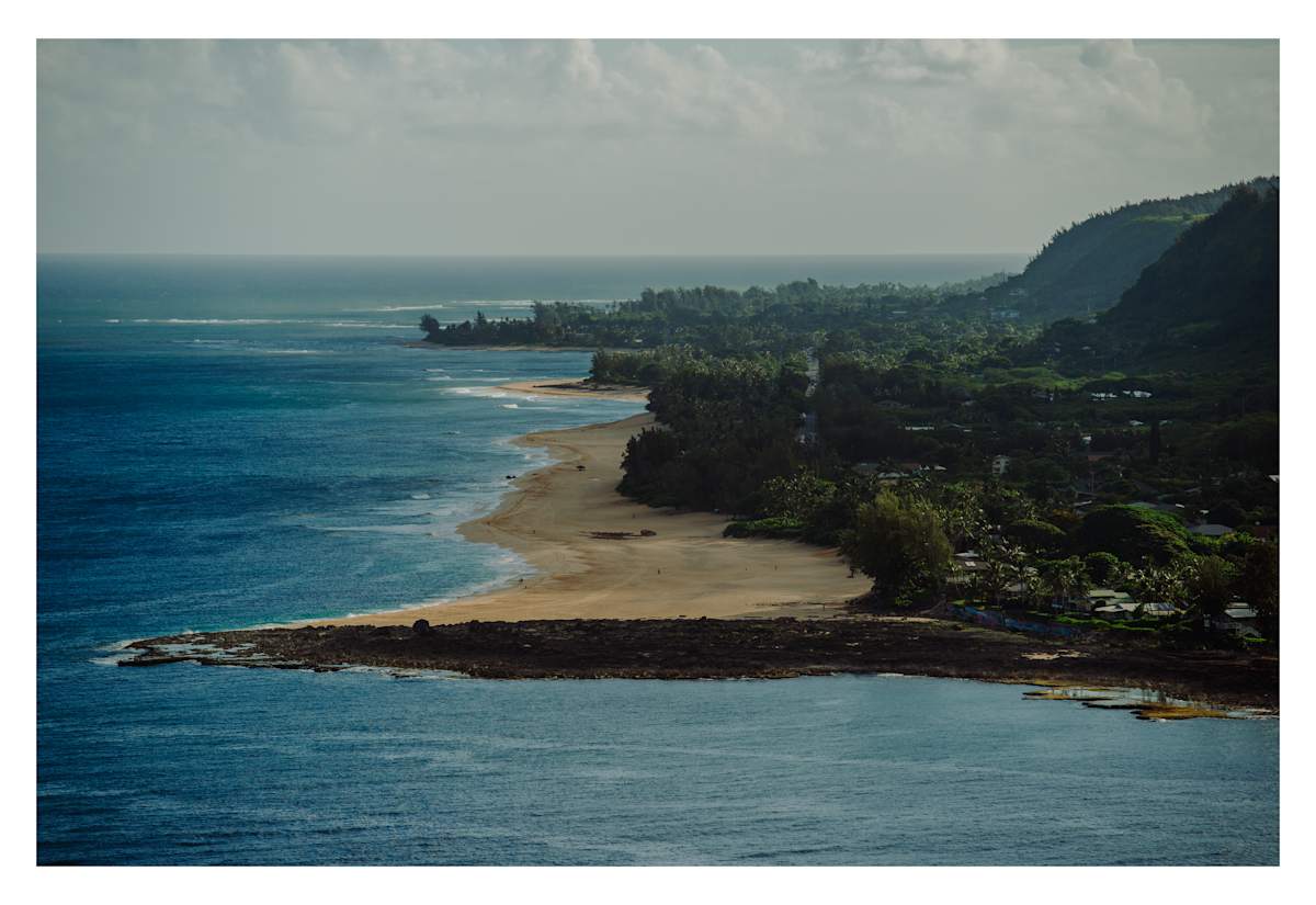 7 Mile Miracle in the Summer by Daniel Russo  Image: During the summer on the North Shore, the sand resets as the tradewinds shift it from north to west, following the winter swells that move it from west to north. This photograph, taken from a Robinson R22 helicopter at about 200 feet above Three Tables, captures that transformation. I used a Nikon 500mm lens and Nikon D3 camera to take this shot. This image always brings me a sense of calm and reminds me of childhood summers spent playing on the beach in solitude.