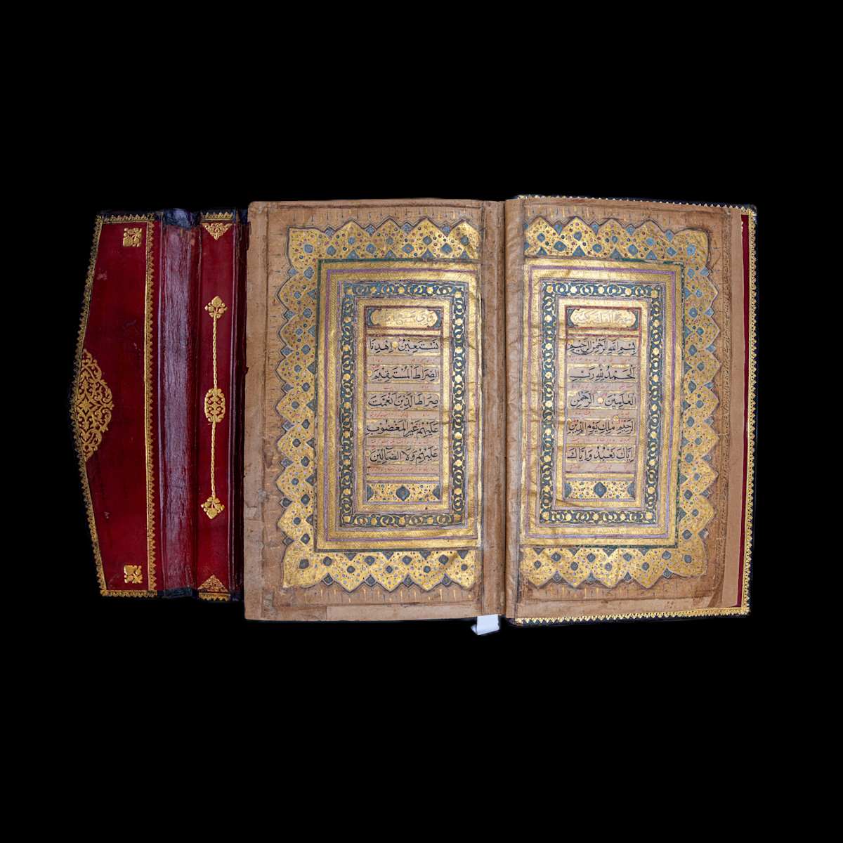 Quran  Image:  Luminous Mughal Qur’an inscribed on paper with 11 lines per page in elegant black naskh and red Persian interlinear translation. Features rich illumination across 9 pages. Bound in deep red leather.
