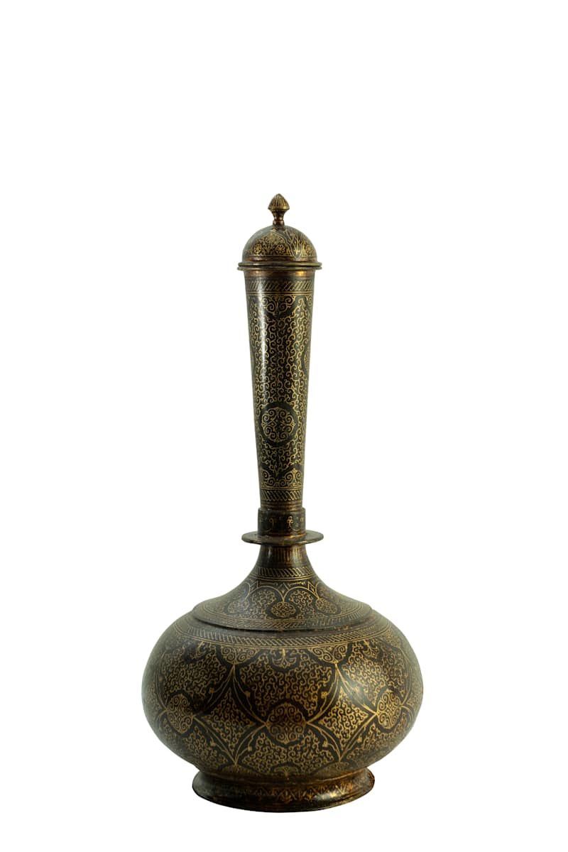 Surahi  Image: This traditional surahi features a bulbous base, tapering neck, and domed lid, richly adorned with dense foliate and geometric patterns in the refined Koftgari technique.

