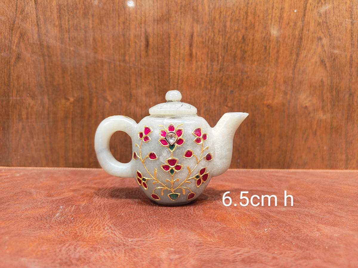 Kettle  Image: This petite  jade kettle is adorned with floral motifs in traditional kundan work, using rubies, emeralds, and gold—showcasing the elegance of Indian decorative artistry in miniature form.