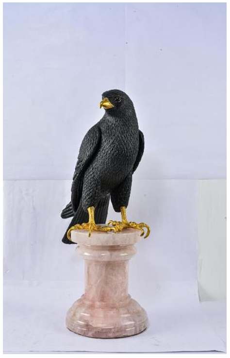 Hawk Sculpture  Image: A contemporary piece carved from natural obsidian, this sleek hawk exudes quiet power with finely detailed feathers and gleaming gold beak and talons. It rests on a polished rose quartz base, symbolizing a balance of strength and serenity.)
This contemporary hawk carved from natural obsidian with gold beak and talons, rests on rose quartz—embodying strength and serenity.
