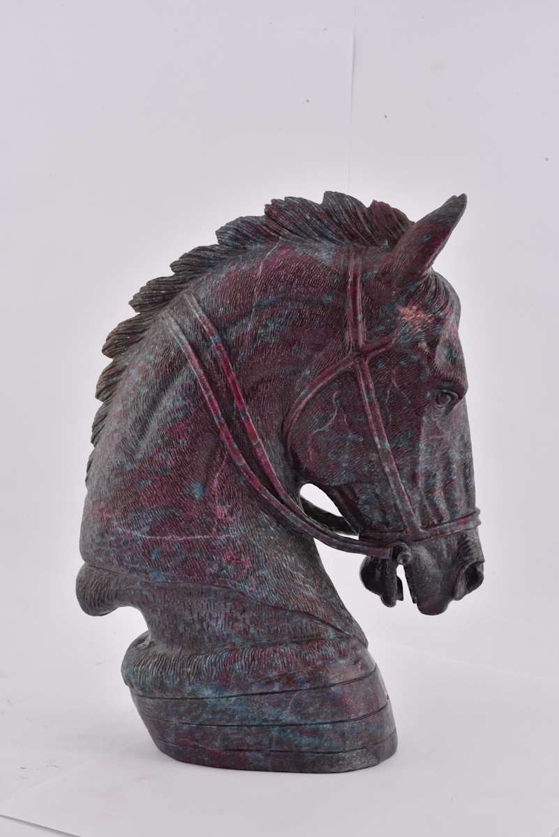 Horse Head  Image: Horse head sculpture in ruby-in-zoisite with finely carved details and natural veining; a contemporary revival of traditional Indian gemstone carving.