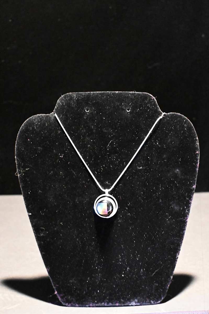 Fused dichroic glass  arc within a circle pendant by Susan Mason  Image: front