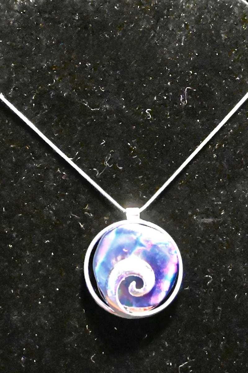 Fused dichroic glass pendant in circular swirl sterling setting by Susan Mason  Image: front view