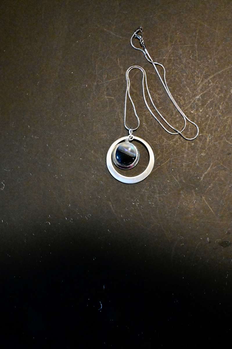 Fused dichroic glass circle drop circle sterling silver setting by Susan Mason  Image: top view