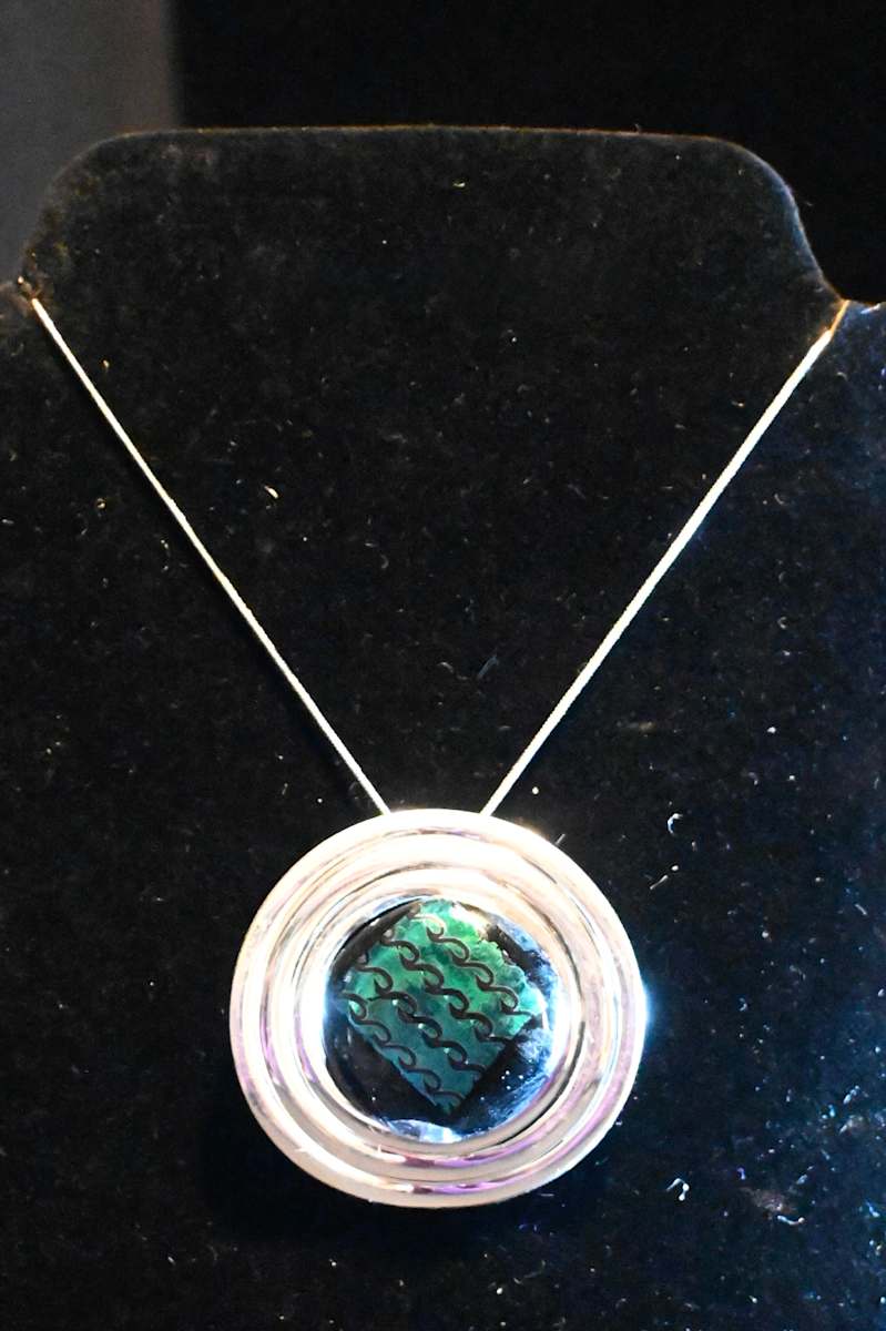Fused dichroic glass green with chain pattern pendant by Susan Mason  Image: front view
