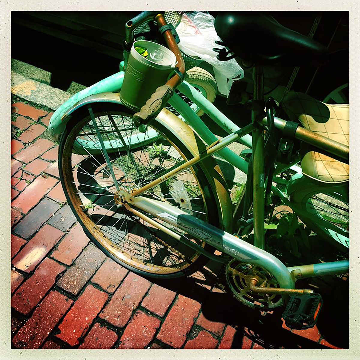 Boston Bikes by Sherry Ross  Image: Strolling through the brick streets of Boston, I happened upon these two retro styled bicycles nestled together. I thought this was the most collegiate Boston visual, especially with the latte left behind.