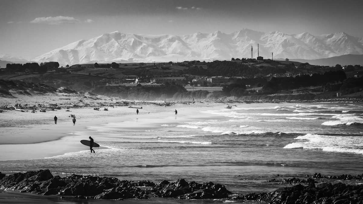 Liencres - Surfing with a Mountain Backdrop by Juan Matorras 