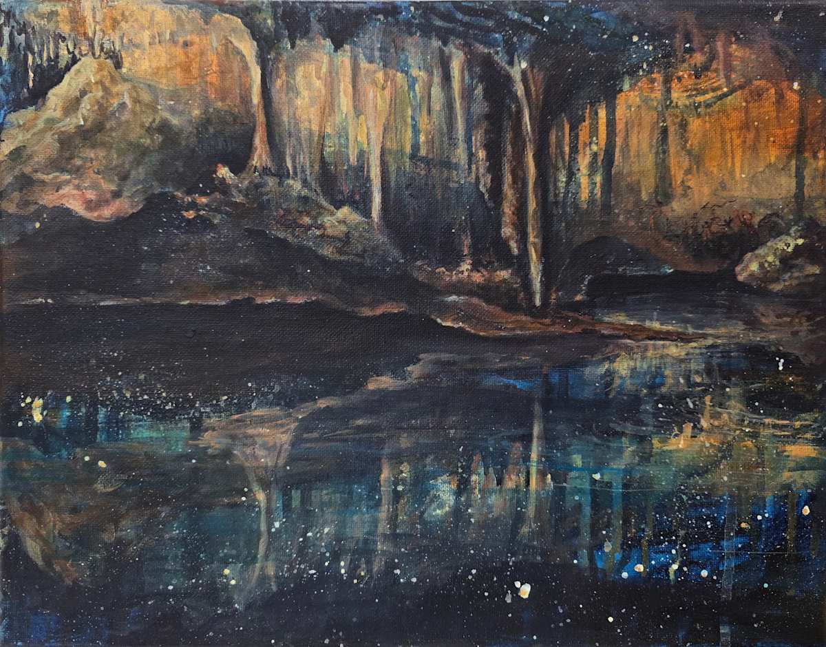 The Cave Remembers The Sky by Tashina Marie  Image: There are places where earth and sky are not opposites, but reflections.
Where stone remembers starlight. Where the ancient dark is not empty, but full of origin.
This painting evokes the cave not just as shelter, but as sanctum—a living chamber carved from time, glowing with the memory of stars. Inspired by natural caverns and the mirrored stillness of underground water, the image transforms a geological space into a celestial one. Stalactites shimmer like nebulae, and the cave’s reflection becomes a cosmos unto itself.
In myth and mystery, the cave is the womb of the world.
It is the place of descent and return—of silence, of becoming.
Inanna knew this path. So did Persephone. So do we, in our own quiet initiations.
The Cave Remembers the Sky is a visual offering to that liminal space between darkness and revelation. A sacred hollow where grief can echo, and light is not extinguished—but distilled.