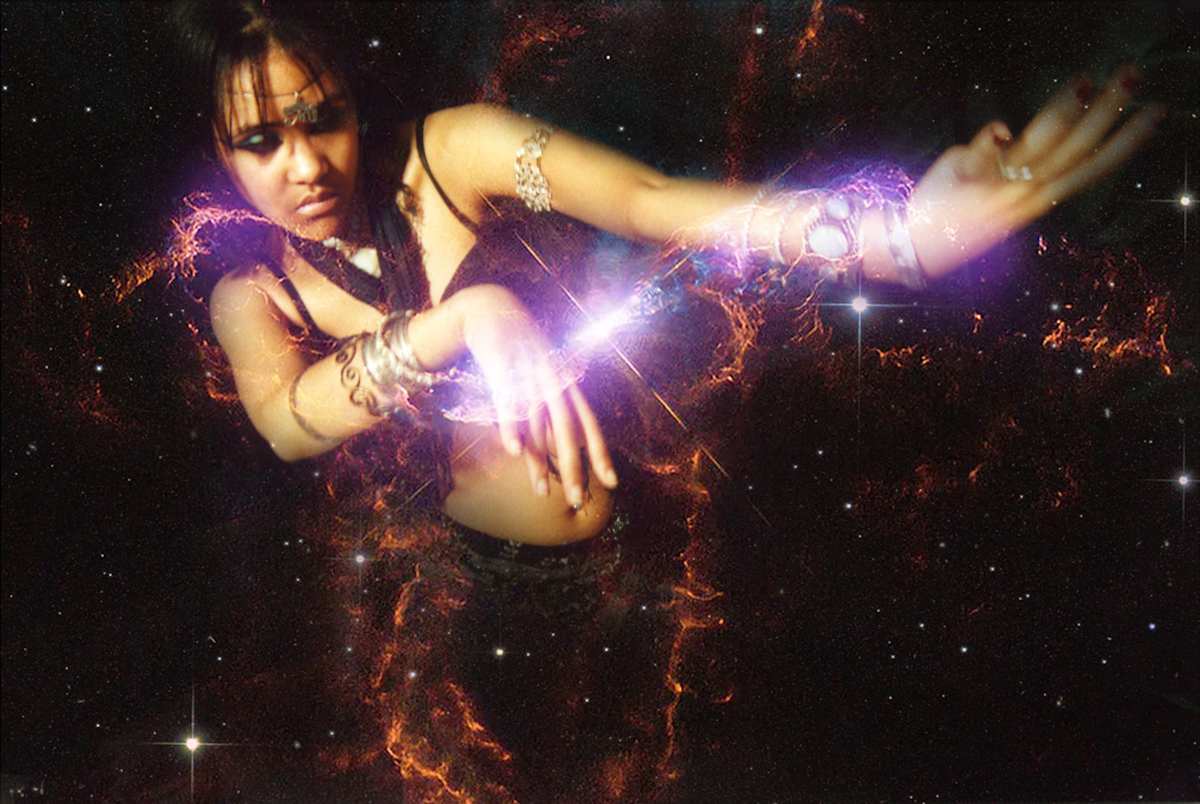 She Who Rewrites the Sky by Tashina Marie  Image: She Who Rewrites the Sky depicts creation not as a fixed inheritance but as an act continually authored from within the body. Here, the figure is neither a witness to the cosmos nor a passive recipient of its laws — she is the instrument through which those laws are altered. Light is not merely illuminating her; it is issuing from her gesture, reforming the stars as if agency itself were a tectonic force.
This work asks us to consider that the world is not only observed but rewritten — again and again — by the ones willing to act upon it. To rewrite the sky is to reject the inevitability of what is given and to enter the responsibility of making: to intervene, to re-shape, and to refuse the permanence of what once seemed immovable.