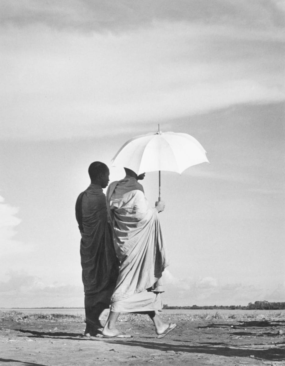 Cambodian Monks by Edward R. Miller  Image: Two monks walking, one with umbrella.