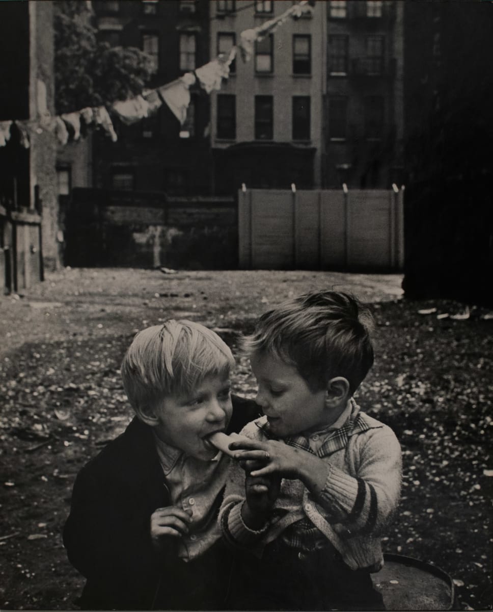 Willie Feeding Banana to a Little Boy by Ken Heyman 