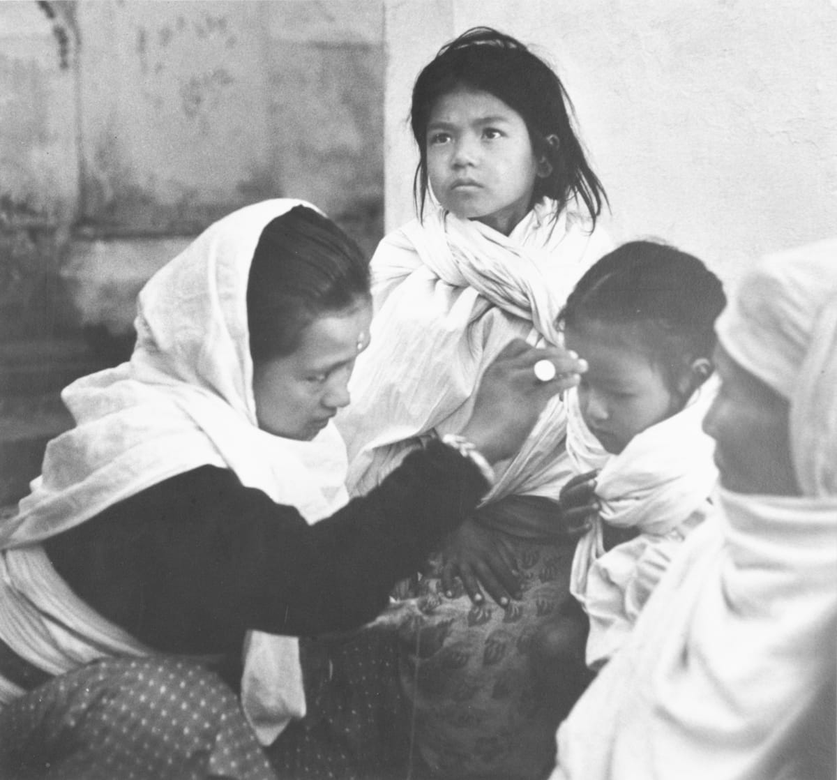 Nepal 1964 by Edward R. Miller  Image: Two adults and two children, all wrapped in white cloth.
