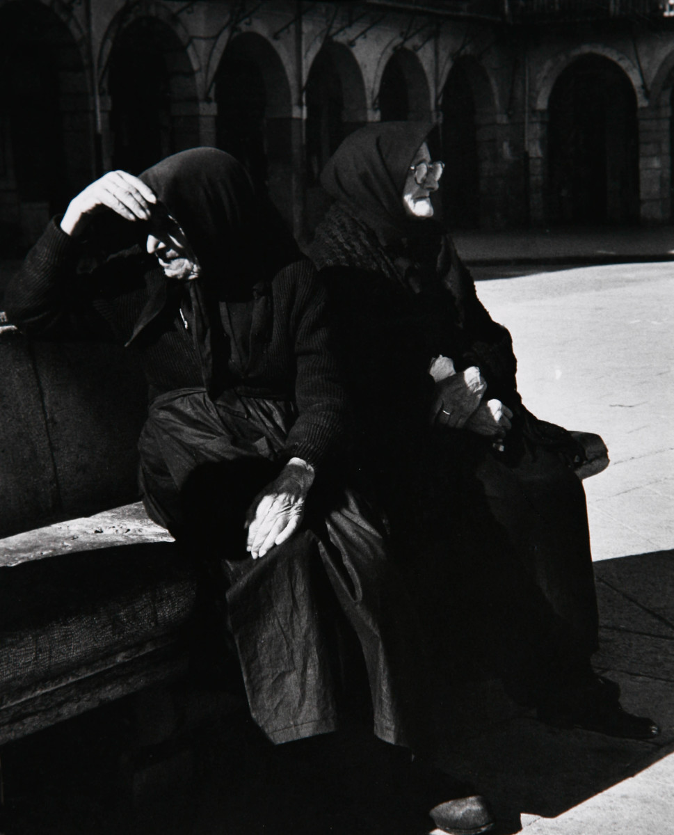 Oviedo, Spain 1962 by Edward R. Miller  Image: Two elderly white people in all black sitting on bench