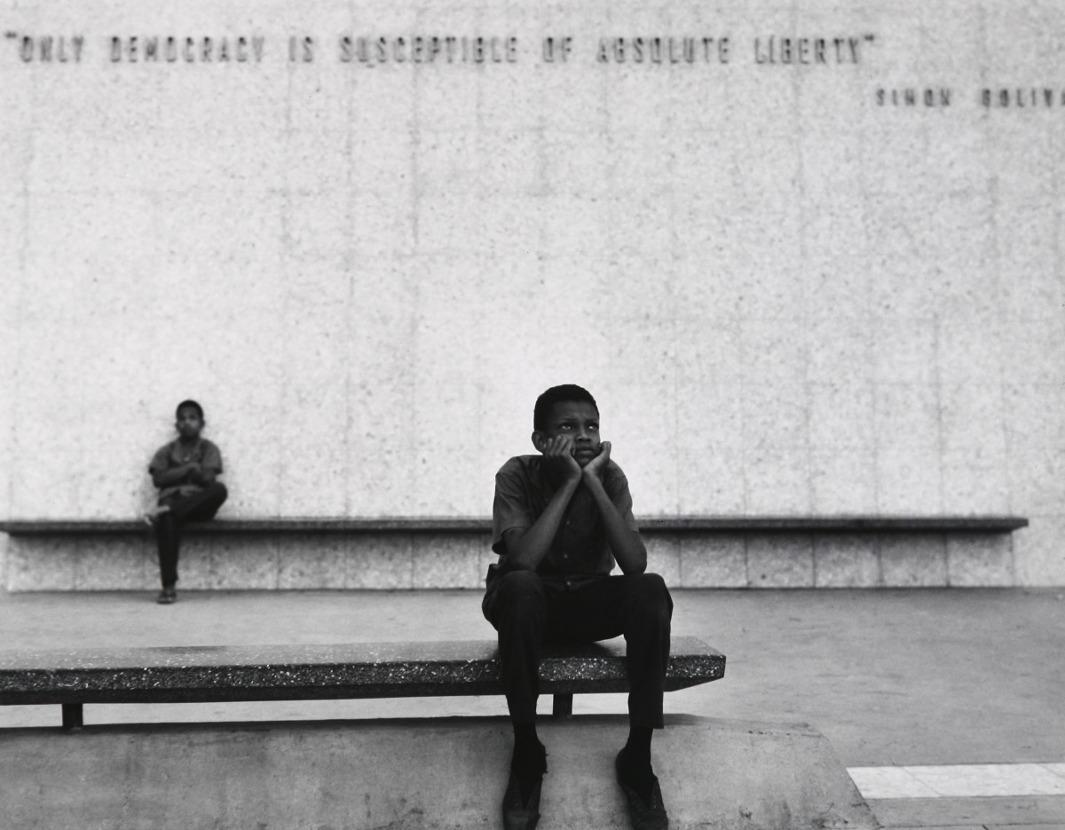 Panama City 1962 by Edward R. Miller  Image: Two black children sitting on benches in Panama city, both benches are offset from one another