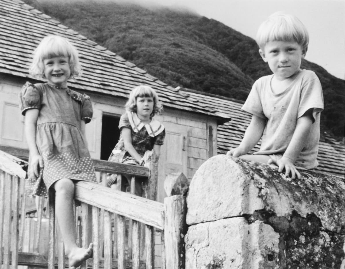 Saba, Netherlands West Indies 1951 by Edward R. Miller  Image: Three white blond children sitting on a fence and stone post in front of house