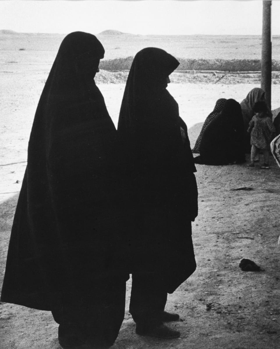 Iraq, 1956 by Edward R. Miller  Image: Two figures in burkas standing in silhouette in desert scape