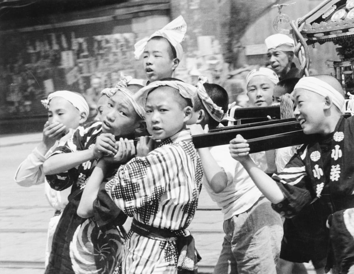 Tokyo, Japan 1948, Boys carrying Shrine by Edward R. Miller  Image: Japanese boys in headbands carrying a shrine on wooden planks