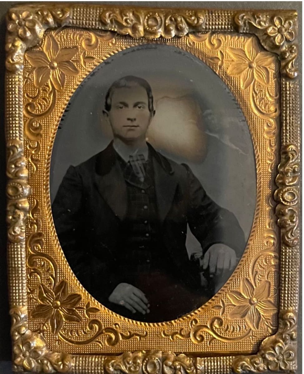 Young Man Sitting with Moon Shaped Damage 