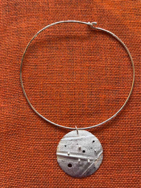 Textured Disc Pendant Necklace by Ichia Tiyi, Image 1.
