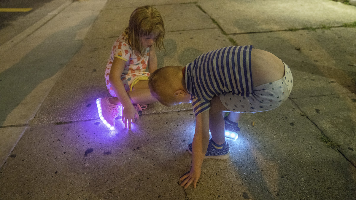 Kids playing on Wildwood sidewalk at Night by Alan Powell 