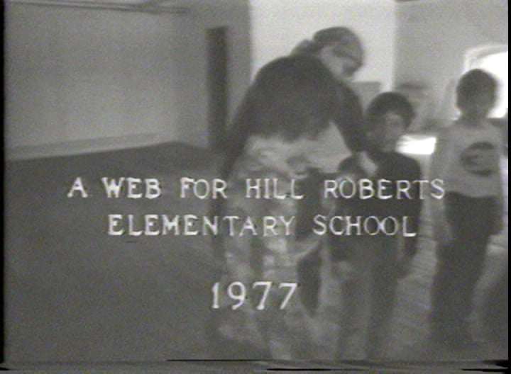 Spiderweb by Alan Powell  Image: Interactive weaving by Connie Coleman, Craftsman in residence with the RI State Council on the Arts. Technique uses the concept of a knitting machine. Using Recycled computer tape and mylar Connie Coleman creates an flexible changeable environmental sculpture. Videotaped by Alan Powell at Electron Movers studio in Providence RI . 