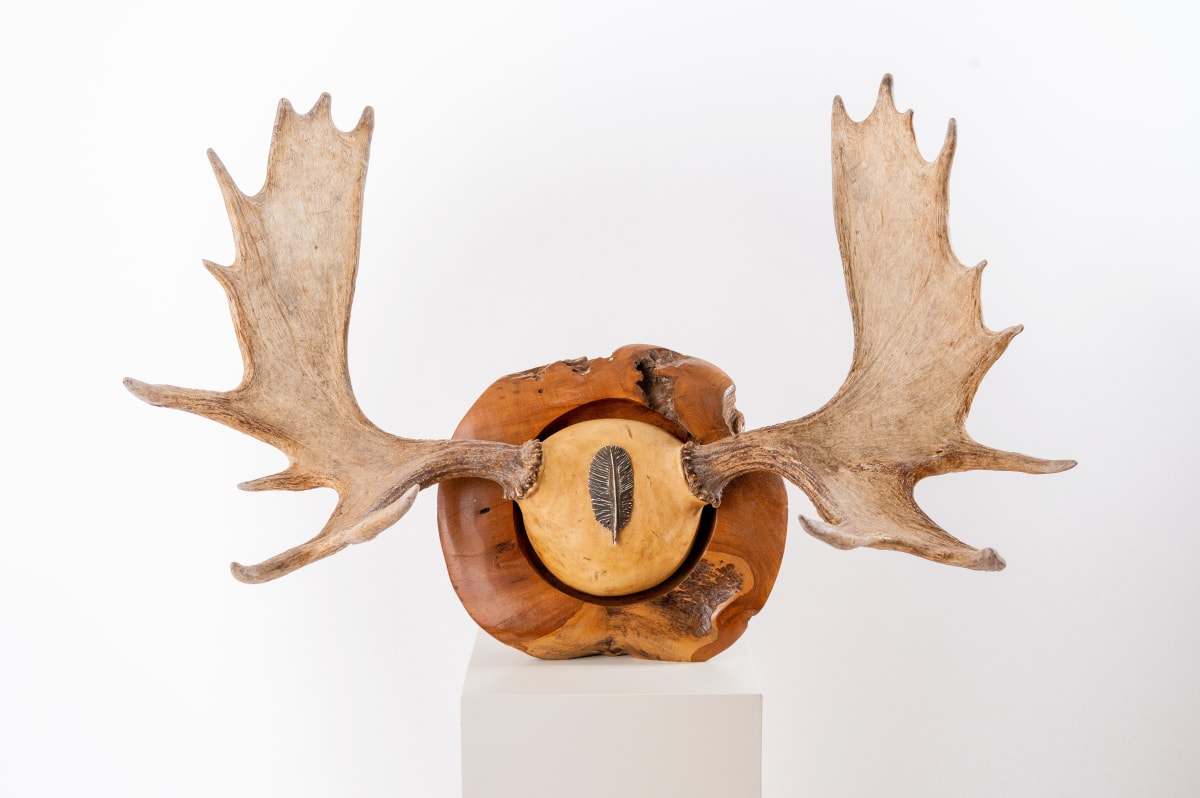 Bullwinkle  Image: Moose horn mounted on an industrial teak bowl.  A feather garnish on mount.