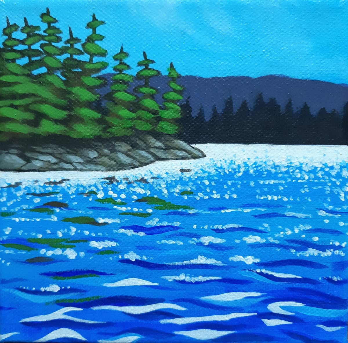 Sparkling Water by Jane Thuss  Image: White sparkles dance on the surface of the blue lake. The pines on the rocky shore are reflected in the waves.