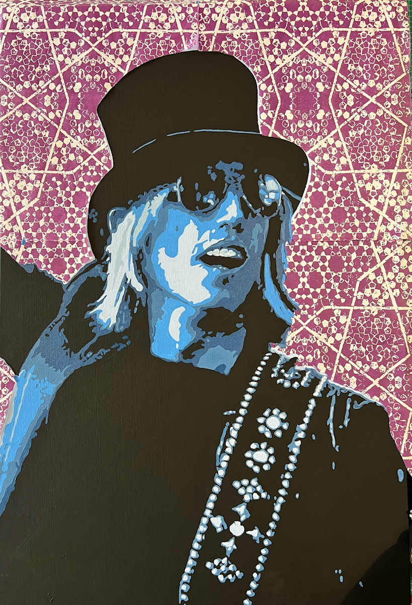 Runnin’ Down a Dream by John McCaskill  Image: This reproduction of the original portrait of Tom Petty captures the rock legend mid-performance, bathed in tonal blues and framed in the sharp contrast of shadow and light. His iconic silhouette—top hat, shades, and guitar strap—emerges boldly against a meticulously printed geometric background, composed of layered woodblock prints.