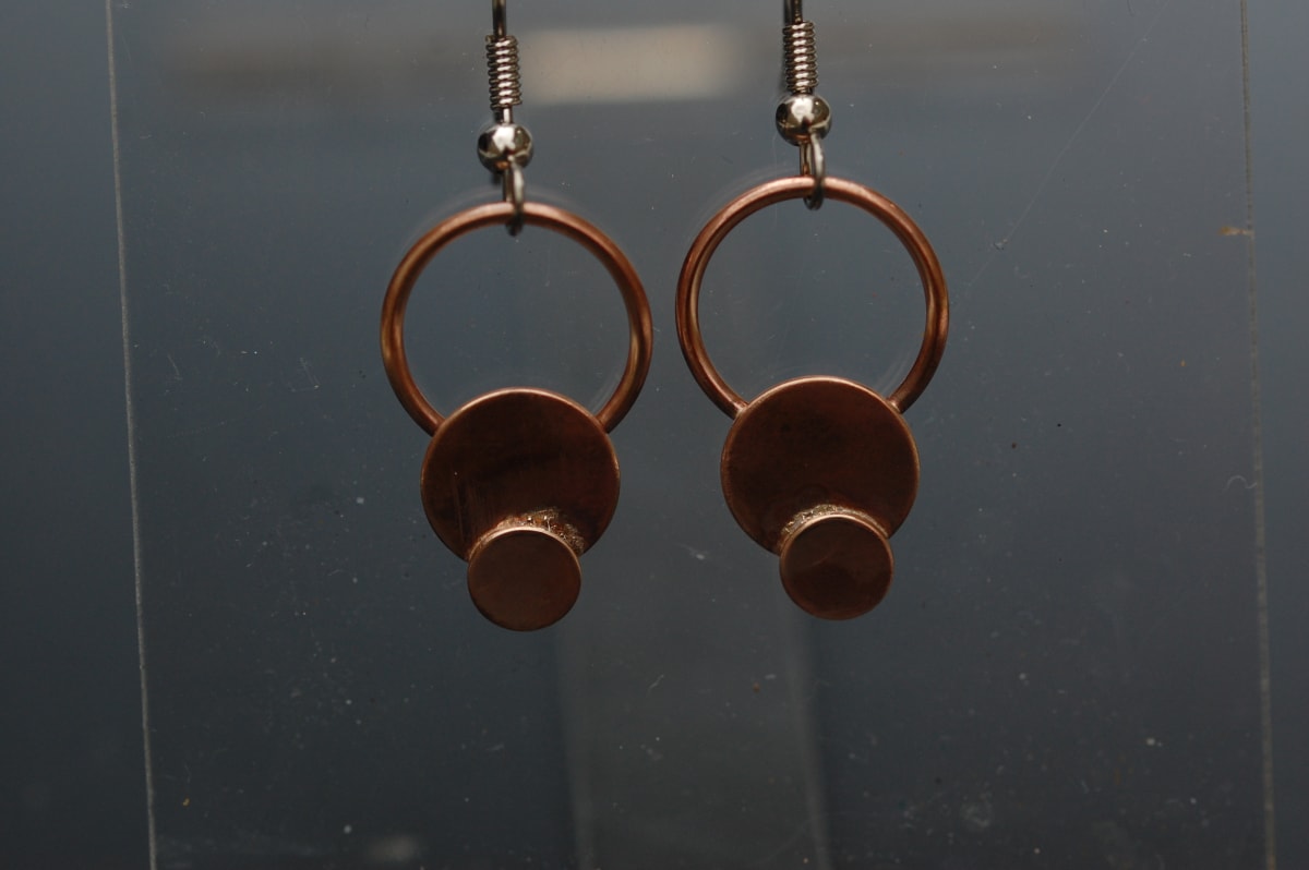 Bronze Disk on Hoops by Susan Baez  Image: 1" x .5"