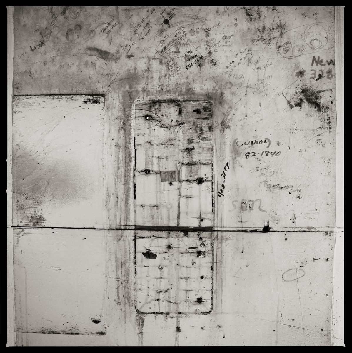 585.325.9301 – Genesee Brewery, 445 Saint Paul Street, Building #6, Rochester, NY 14605 by Eric T. Kunsman  Image: ID: A black and white image shows an empty cement wall that is cracked and has a rectangular outline where a payphone used to be mounted.  There are holes around the inside of the rectangle were there were screws.