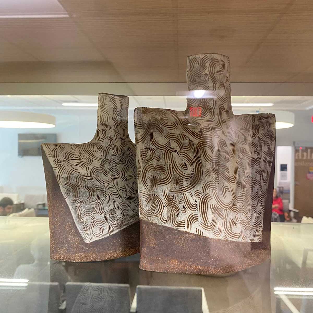 Vintage Sgraffito Bottles by Margaret K. Weinberg  Image: Creating in clay is so intriguing, also challenging as well as intrinsically satisfying for me. Clay is not only a medium of contrasts, but also of harmonies. Experiences with clay are cerebral/intuitive; physical/sensual; well-planned/spontaneous; predictable/unexpected; exhausting/exhilarating, and more. The notions, reflections and thoughts that lurk and sometimes dance in my head give rise to doodles and small sketches which insist on being realized and expressed in clay. Revisions continue as ideas meet reality. My work is mostly functional. I hand-build in stoneware, slip decorate at times, bisque fire, and glaze fire to cone 6. [2232F].