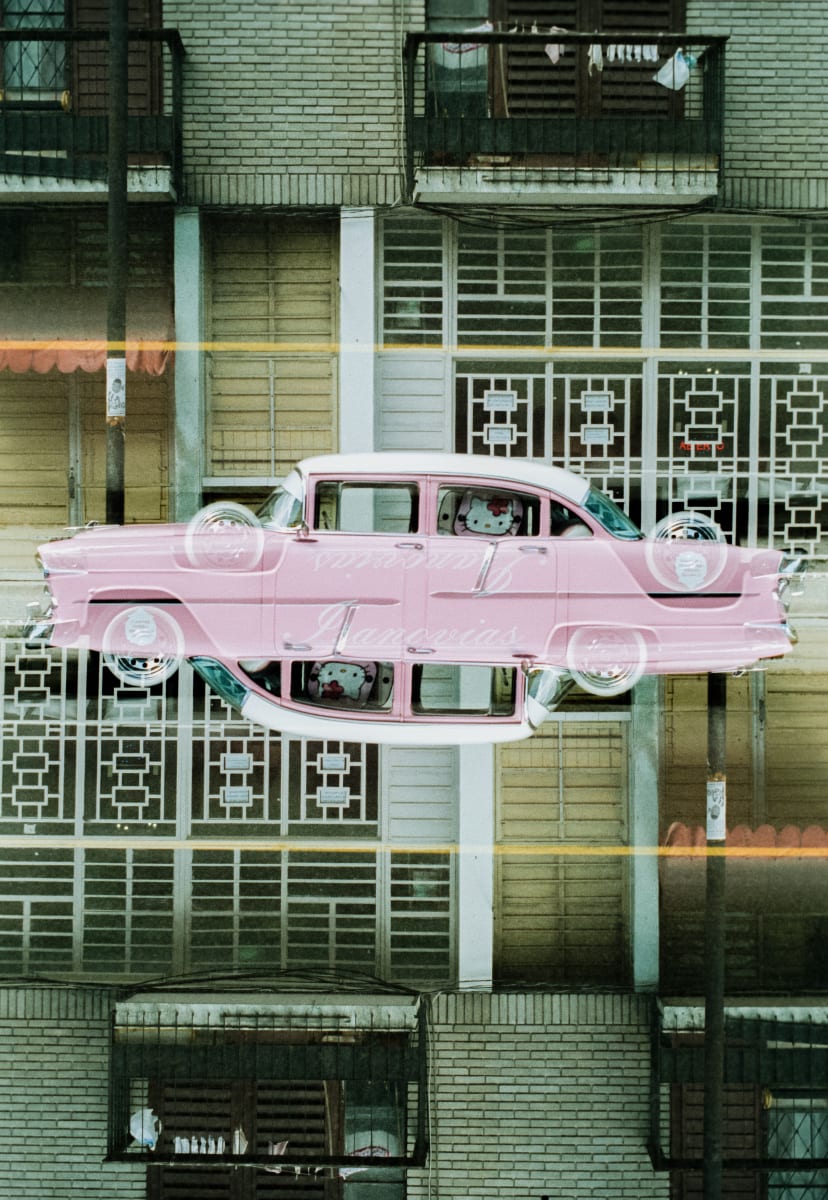 Havana #8 by Robin Vandenabeele  Image: Pink Hello Kitty themed Classic car parked in Havana, Cuba.
This is a print based on a handheld made double exposure of the same subject, with a simple rotation in between exposures. Light and dark play with each other and the merged results make for a new twisted reality. 
No AI or photoshop was used to create this artwork.