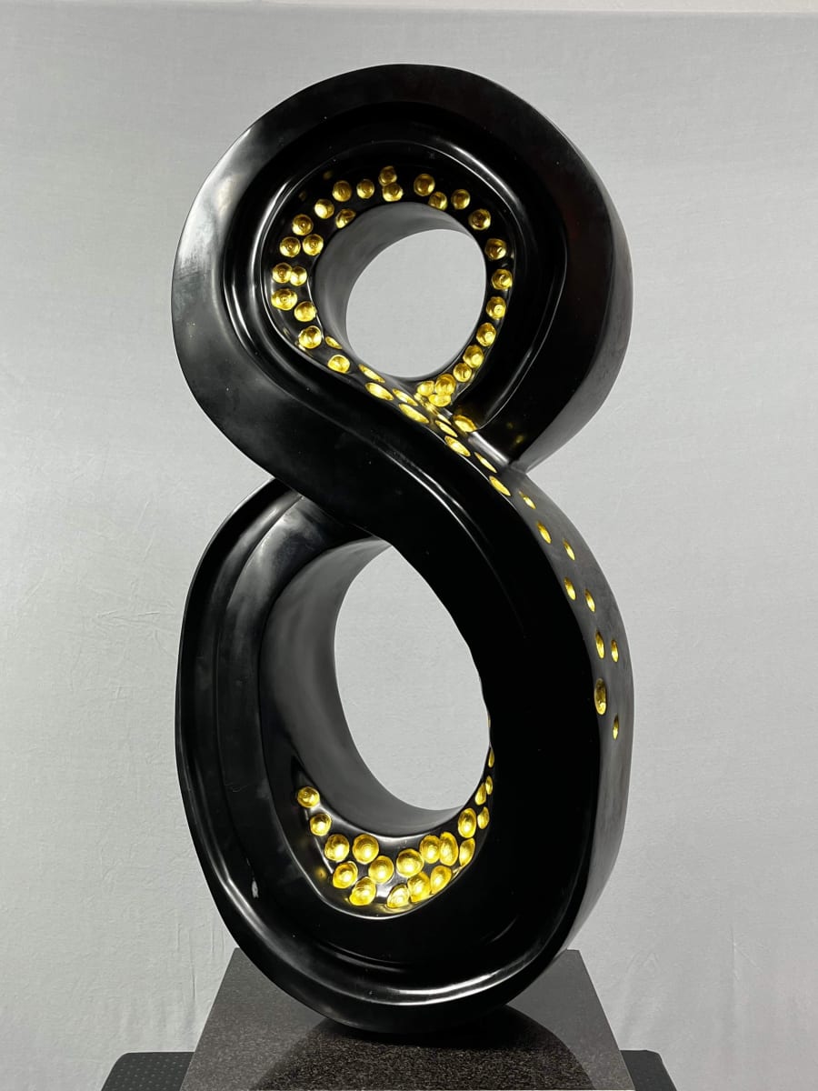 Lucky 8 by Scott Gentry Sculpture  Image: Scott Gentry Sculpture. "Lucky 8" front view. Atlantic black marble with gold leaf on black granite base. Measures 31.5H x 13.5W x 12D inches.