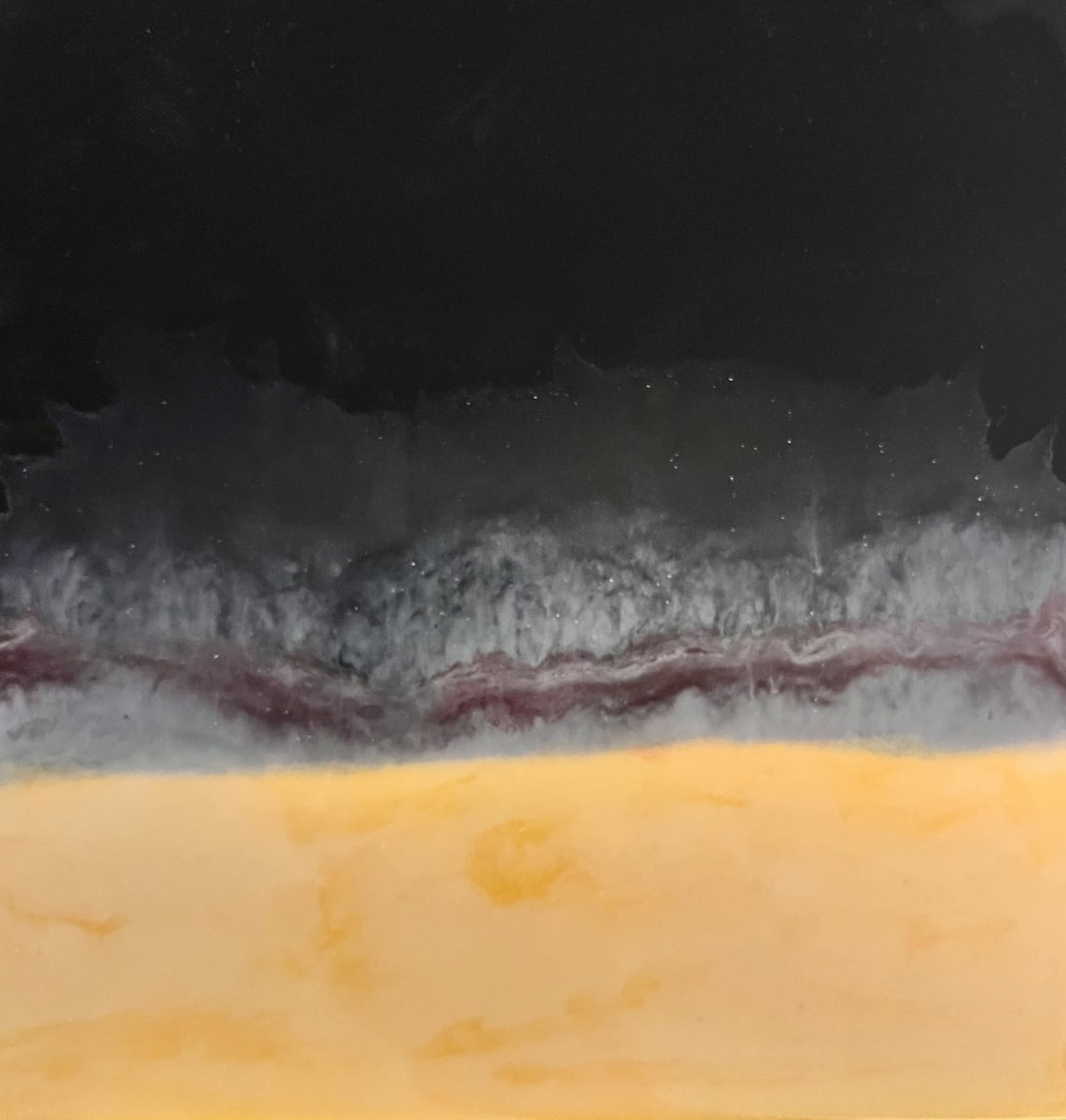 Unexpected Series - #10 by Kathie Collinson  Image: Black and yellow acrylic paint with red and white tinted resin.