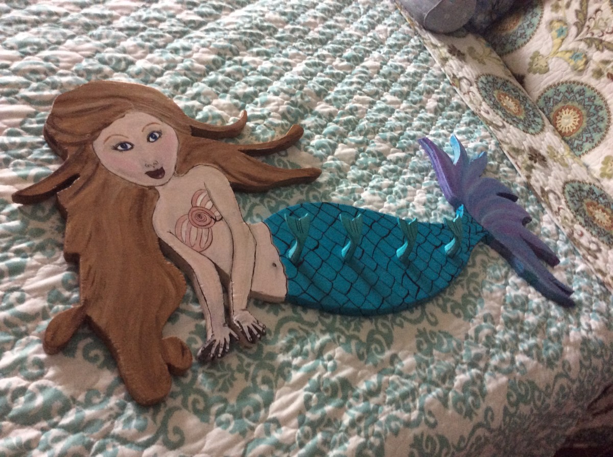 Hand cut and painted wooden mermaid hooks. by Heather Medrano 