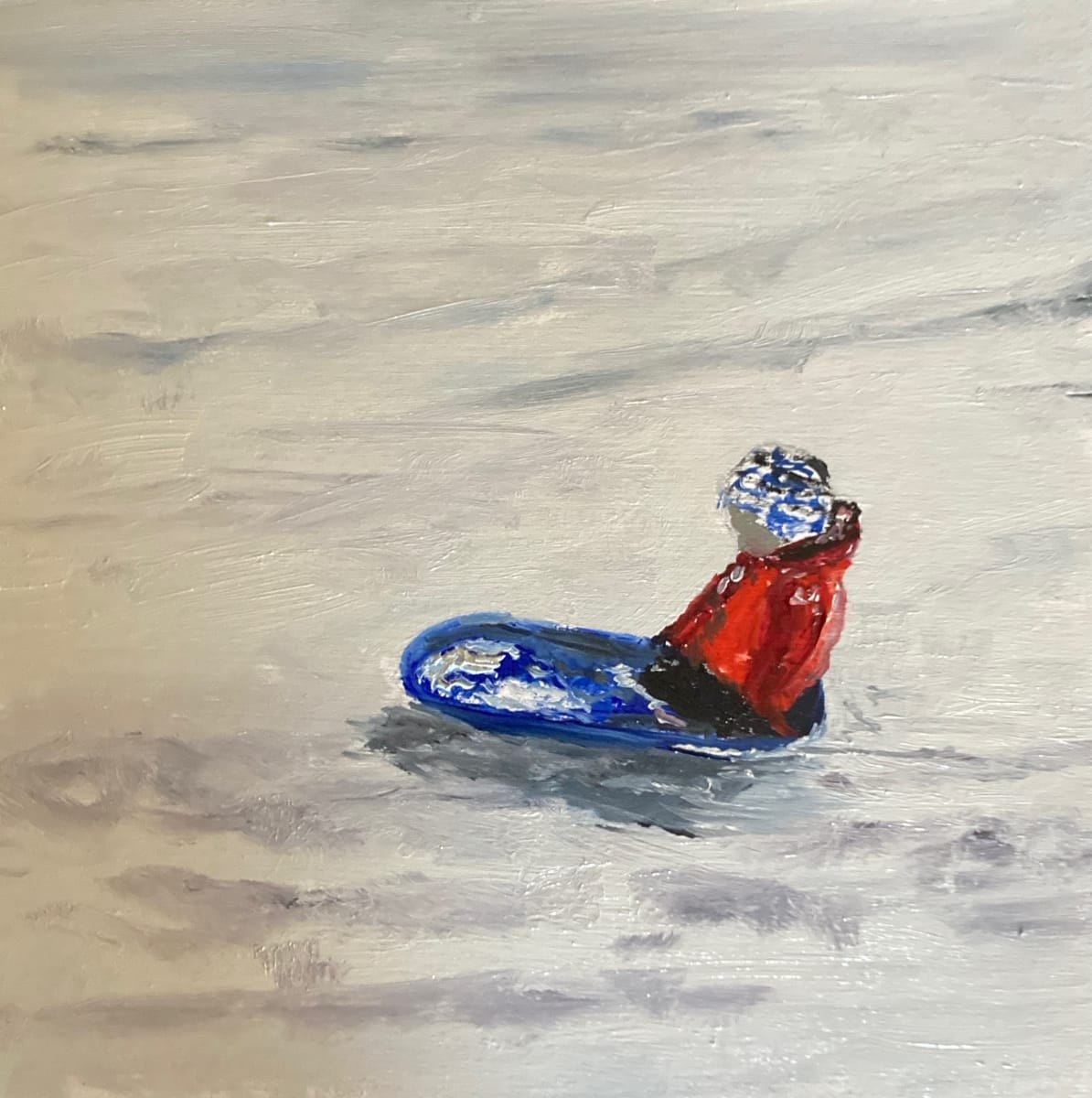 Snow Hill by Chantal  Image: small child in tobogan at the base of a snow hill